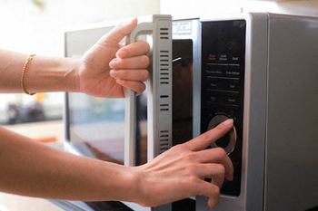 Person opening a microwave
